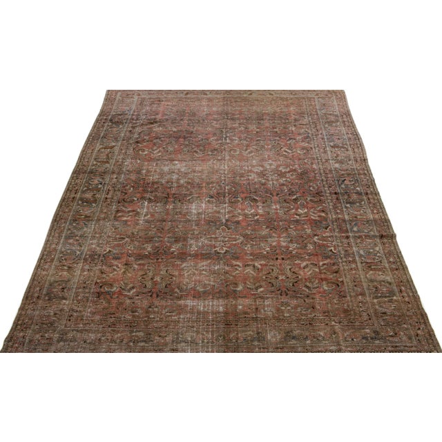 Beautiful Antique Malayer hand-knotted wool rug with a red-rust color field. This Persian rug has gray and brown accents...