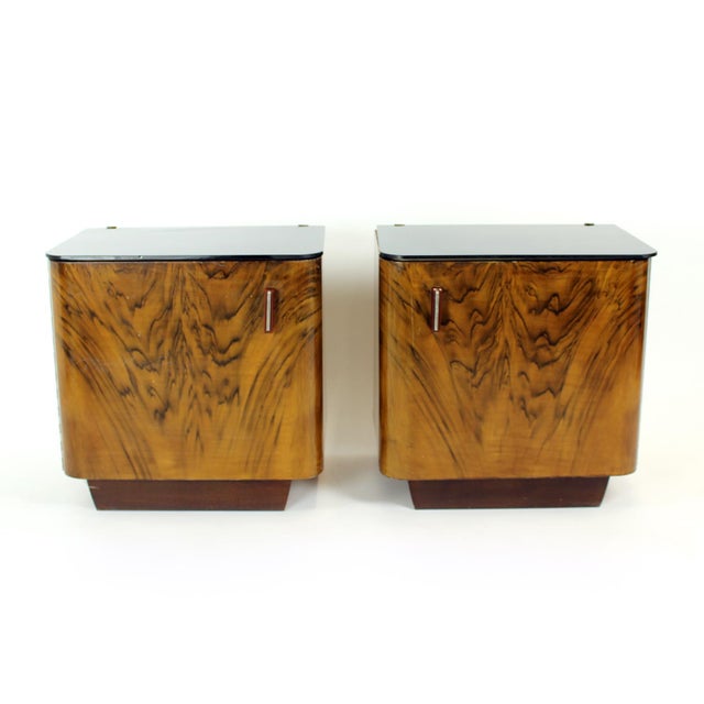 This striking pair of bedside tables was produced in Czechoslovakia during the 1940s, capturing the refined elegance of...