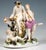 Original rococo meissen group from the 18th century. A visibly drunken silenus, crowned with a wreath of vines, sitting on...