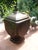 An antique, large lidded box made of brass sheet, with embossed laurel wreaths and another floral cross motif. An...