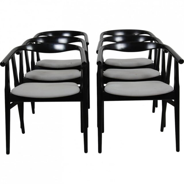 Set of 6 Hans Wegner GE-525 chairs with a black painted frame and seats upholstered in grey fabric. The chairs are from...