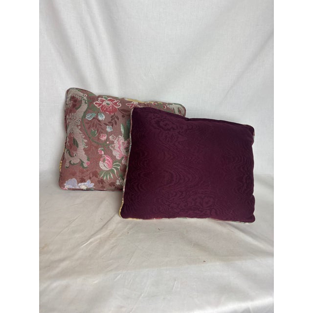 Pair of gorgeous dual-sided floral pillows. The solid plum side has a subtle swirling pattern, while the multicolored...