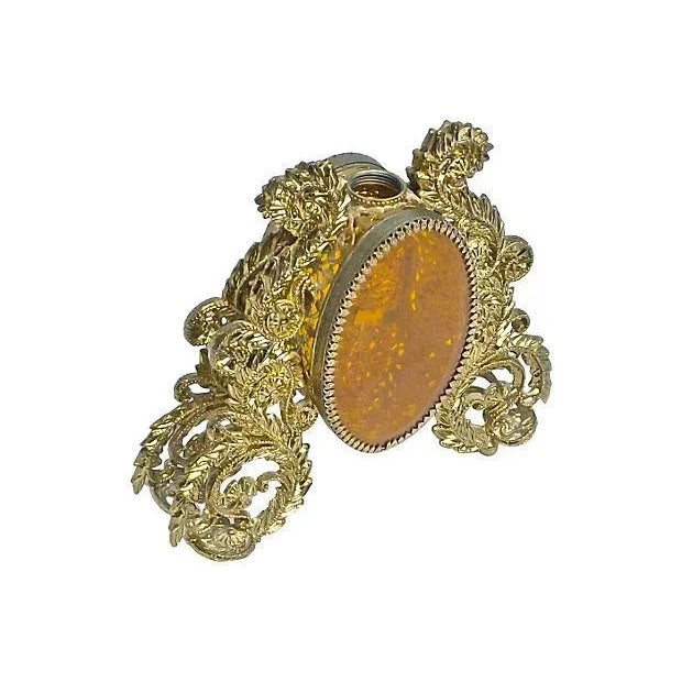 This is a vintage, 1960s, brass, amber, and acrylic perfume flacon bottle. It has robust leaf and floral filligree designs...