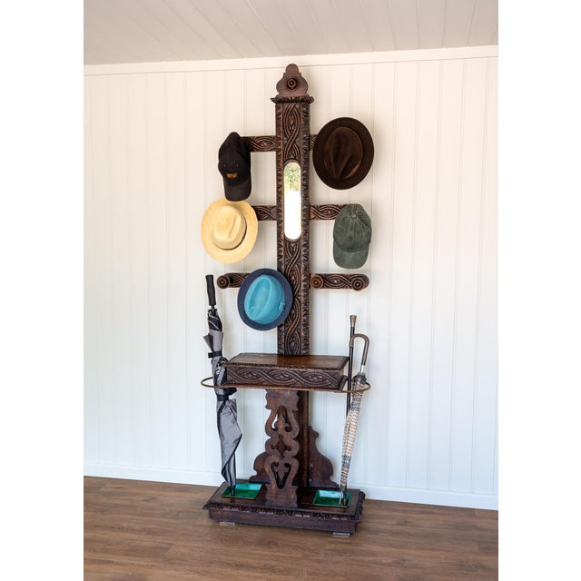 An exceedingly charming, interesting and rare Victorian carved oak hallway hat stand in good antique condition. Made in...