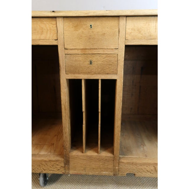 Early 20th-century oak counter. The front is carved with floral and shell motifs, and four columns with capitals at the...