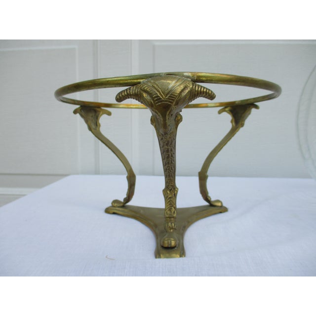 This brass-based, crackled glass bowl has stylized rams’ heads at the top of the brass supports. The bowl could be used to...