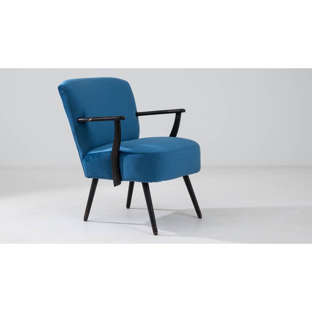 Enliven your space with the vibrant allure of this 20th Century Danish upholstered armchair, a piece that artfully...
