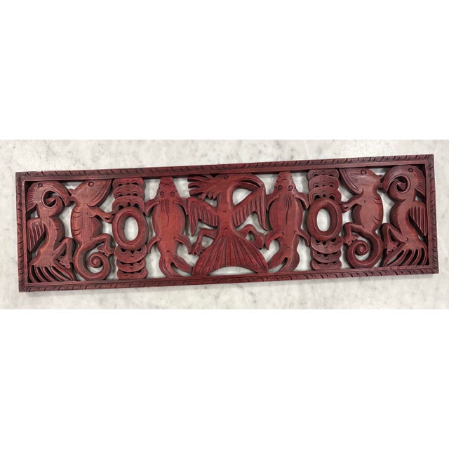 This unique piece of art is a captivating blend of nature and craftsmanship. Hand-carved from wood, and red in color, it...