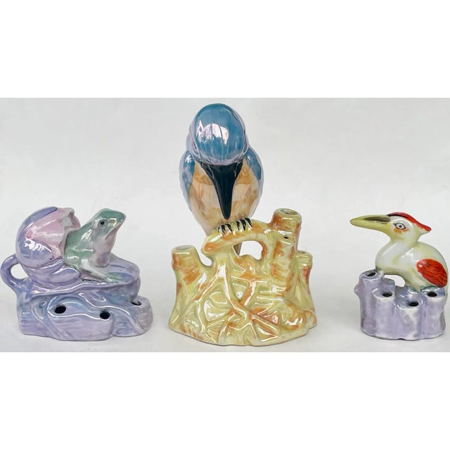 Set of three vintage ceramic flower frogs featuring tropical birds and frogs‚ playful and functional for floral arranging....