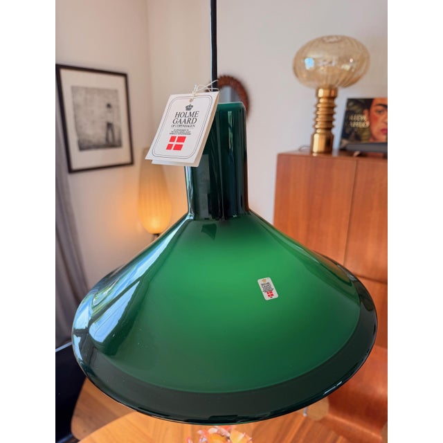 Designed in 1972 by Michael Bang for Holmegaard, Denmark. Mouth-blown, green overlaid opal glass with a white interior....