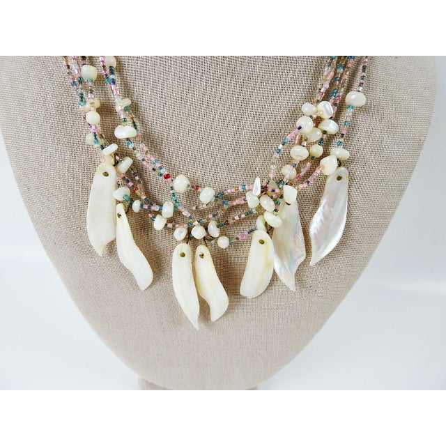 1990's one of a kind artist studio made beaded necklace using mother of pearl and light blue and pink seed beads. By Linda...