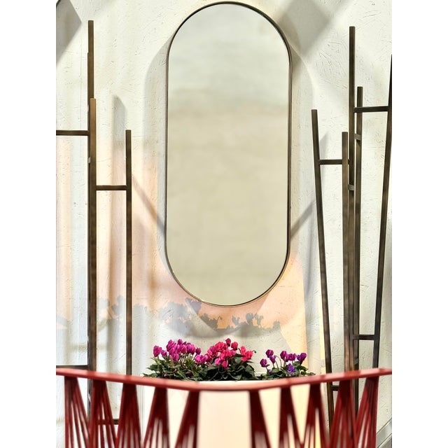 Mizar is an oval metal wall mirror made in Italy, characterized by an elegant and well-proportioned shape. The structure...