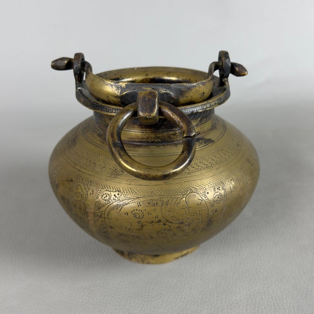 A rare and evocative Indian devotional vessel with a removable handle (traditionally identified as a ceremonial Lota or...