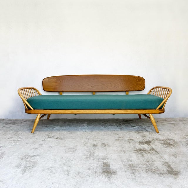Ercol Model 355 day bed from the 1960s. Solid elm construction throughout. Large curved elm backrest attaches via metal...