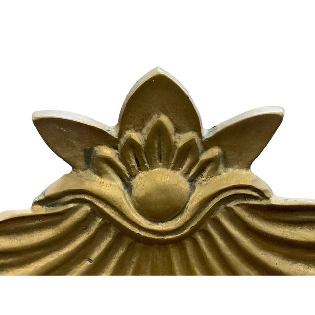 These wall brackets feature a brass scallop shell relief design, adding a touch of coastal or classical charm to any...