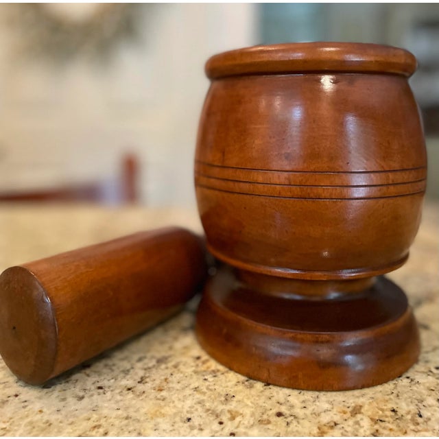 This 18th century English treen mortar and pestle is in exquisite condition; hand turned and carved from a single piece of...