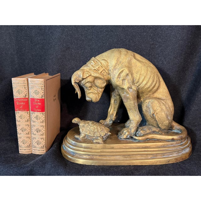 This is a bronze figurine titled Chien à la tortue (Dog with Tortoise), depicting a hound observing a turtle, originally...