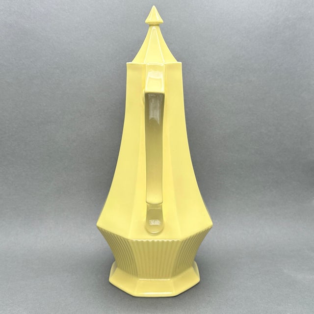 • This striking vintage coffee pot features a vibrant yellow glaze and a distinct geometric, octagonal shape synonymous...