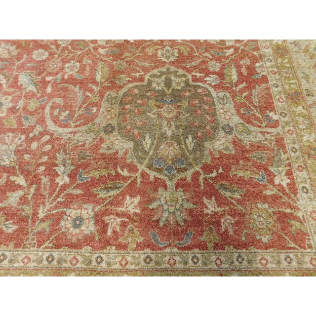 A hand knotted wool pile rug in super fine quality. Terra Cota field within very light green border.