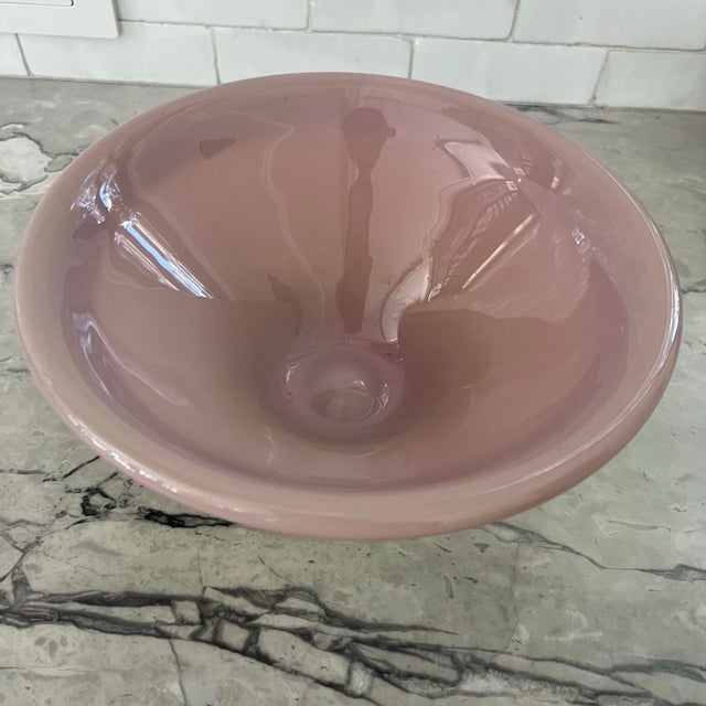 Spectacular hand blown glass bowl in the style of murano. No signature noted. Features a pale pink interior and lip with a...