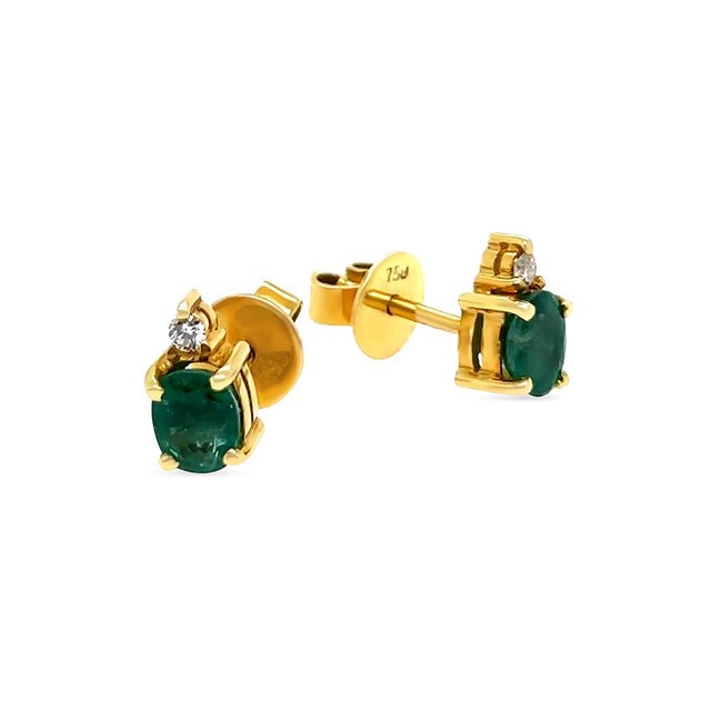 A refined pair of emerald and diamond stud earrings crafted in 18ct yellow gold, featuring vibrant oval emeralds accented...