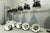Industrial light fixtures in their original condition; the electrical system requires inspection; the enameled shades are...