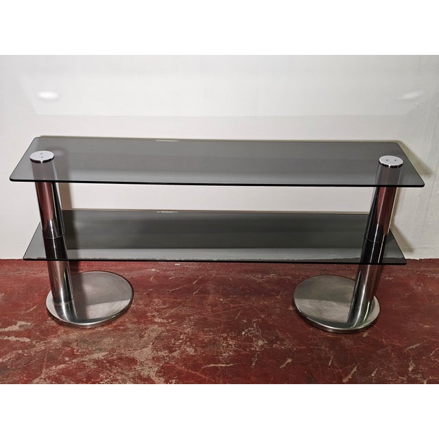 Italian steel and smoked glass console table dating back to the 1970s. Beautiful Space Age design typical of the era. Good...