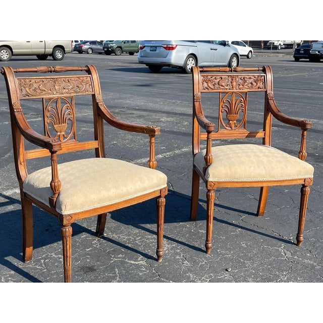 Lovely pr of French Directoire arm chairs, elegantly carved with swans, fleur De Lis and Sunflowers on the arm rests thus...