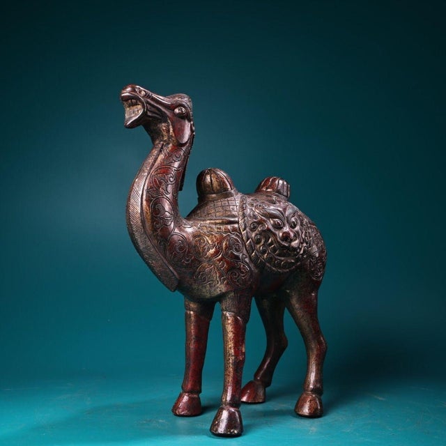 This is a finely cast gilt copper figurine of a Bactrian camel, featuring elaborate high-relief (repoussé) and engraved...