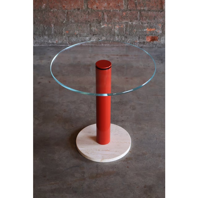A vintage, post-modern drinks table featuring a glass top on a red metal and travertine stone base. In excellent...