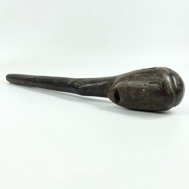 A Dinka cattle scepter is a carved wooden staff associated with the pastoral traditions of the Dinka people of South...