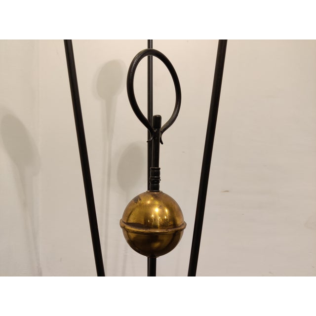 Mid century floor lamp with three coloured lamp shades and white glasses. Eye catching designwith a brass center sphere....