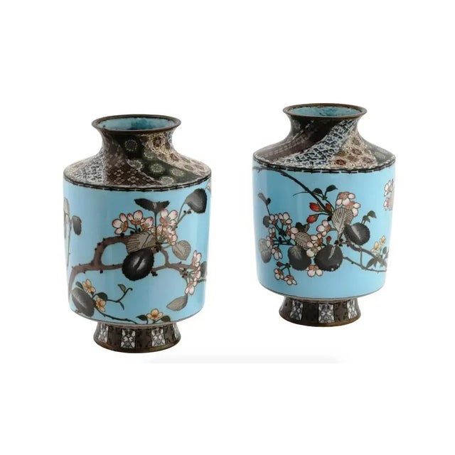 A pair of antique Japanese copper vases with cloisonne enamel design. Late Meiji period, before 1912. Cylindrical shape...