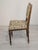Antique Louis XVI-style chair from France, with a wooden frame and floral upholstery. Simple, elegant design with...