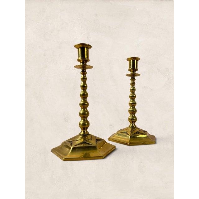 Brass candlesticks earn their place through proportion, and this pair gets it right. The hexagonal bases give them a...