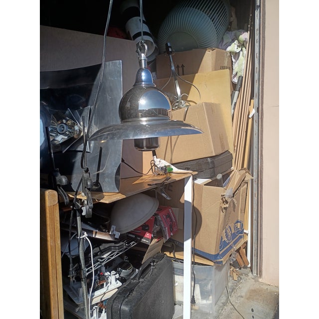 this is a polished metal pendant lamp with a space age flair by design it works also as mid century style but people refer...