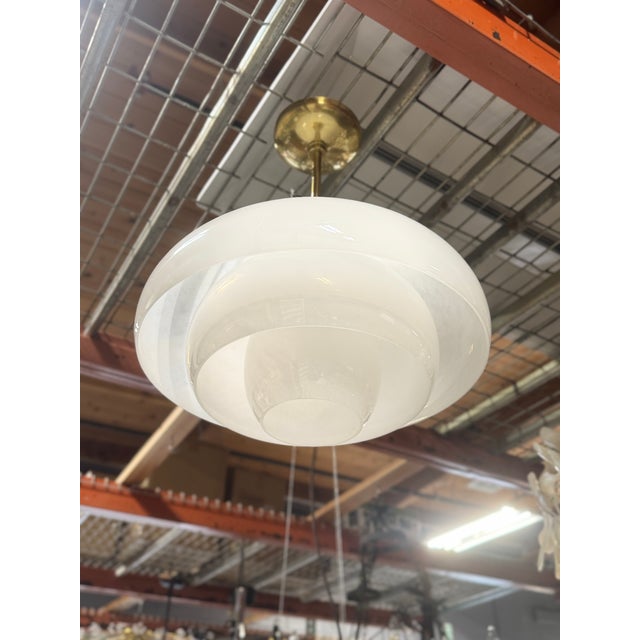 The Auburndale Pendant from Hudson Valley Lighting stacks mushroom-shaped glass shades like a delicate sculpture floating...