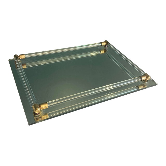 A very nice footed vintage tray. It features lucite and brass bars to hold items. Nice vintage condition.