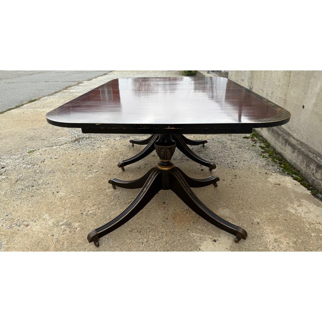A striking vintage dining table by Union National Furniture of Jamestown, New York, known for its refined craftsmanship...