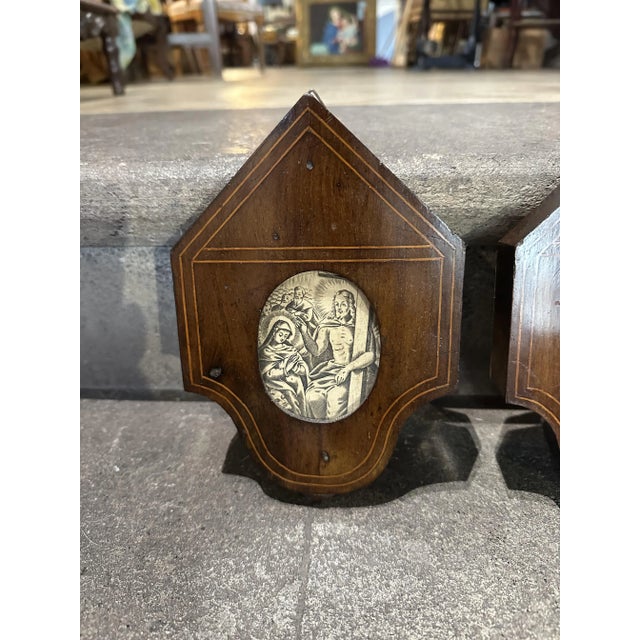 Particular pair of 19th century engravings mounted on solid wood storm frames, depicting two biblical scenes.