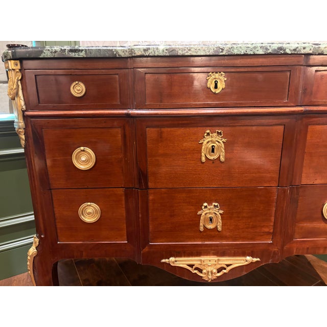 A beautiful mahogany commode from the late 18th century. It has a rich green antico verde break-fronted marble top that...