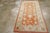 A vintage Turkish Oushak throw rug. The warm salmon – rust ground displays a spacious array of various types of palmettes,...