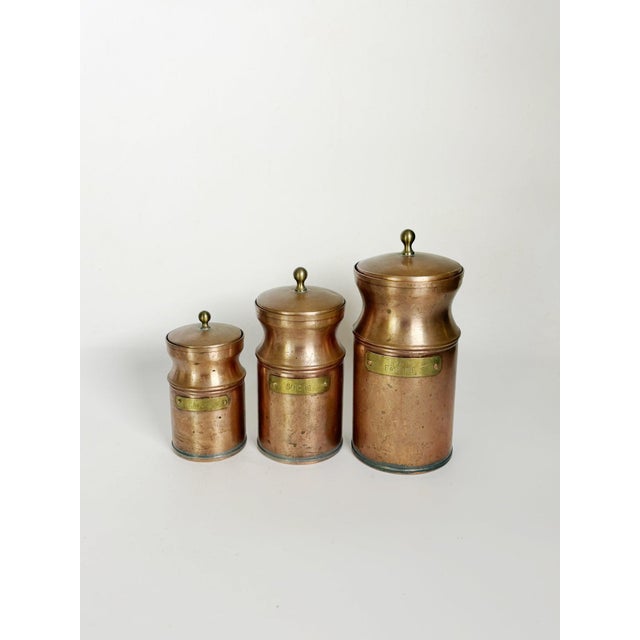 Charming set of three French copper kitchen canisters dating from the 1960s. Each cylindrical container features a gently...
