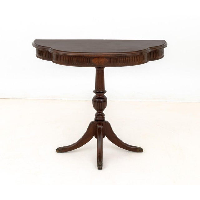Neoclassical Style Mahogany Demilune Table, with three legs terminating in lion's paw feet. 32" H x 36" W x 15" D....