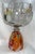 A large crystal punch bowl with fish decorations around it. Base is upside down colorful art cone. Great red, yellow and...