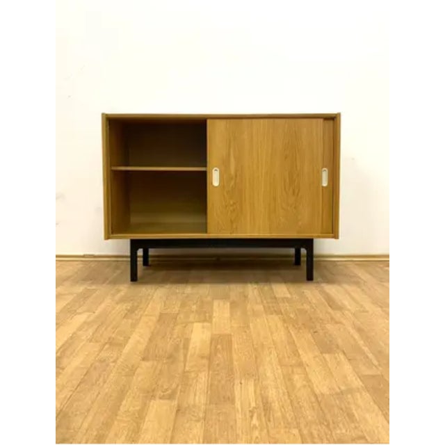 A vintage chest of drawers designed by Jiří Jiroutek in the 1960s, produced in Czechoslovakia. The piece reflects the...