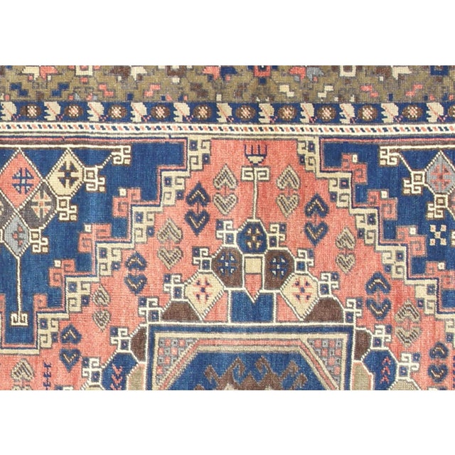 A vintage Turkish Oushak measuring 5'5" x 10'11", hand-woven with wool on wool foundation. This piece displays the...