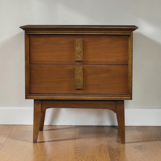 Bassett Aztec nightstand, vintage 1960s. The American made nightstand features two drawers with distinctive Aztec inspired...