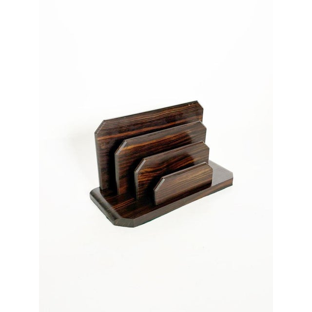 An elegant wooden desk letter holder, crafted from veneer with contrasting grain patterns that highlight the material's...