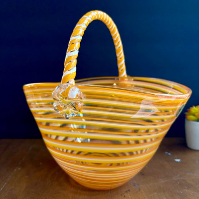 Add a vibrant statement piece to your décor with this beautiful vintage art glass basket by BLOCK Crystal. Featuring...